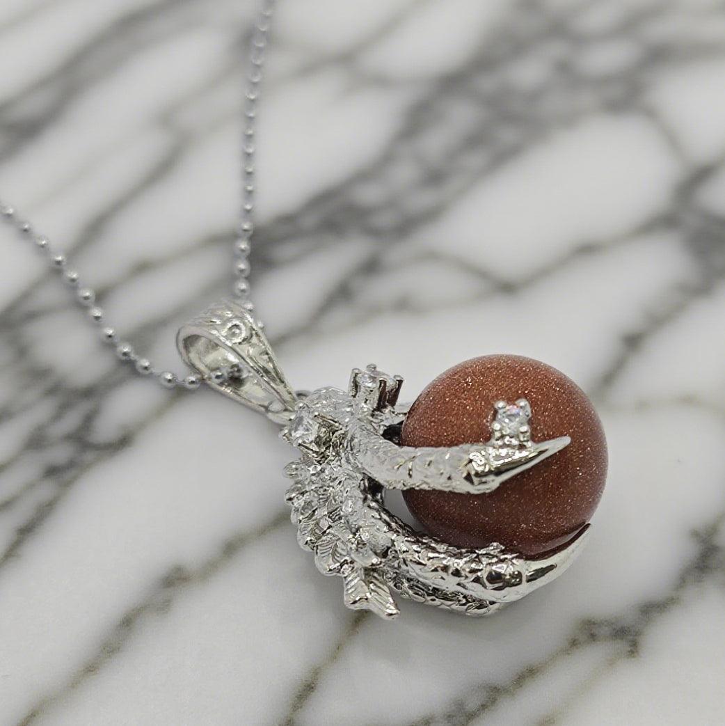 “Léger” Dragon Claw Orb Pendant — Goldstone Quartz