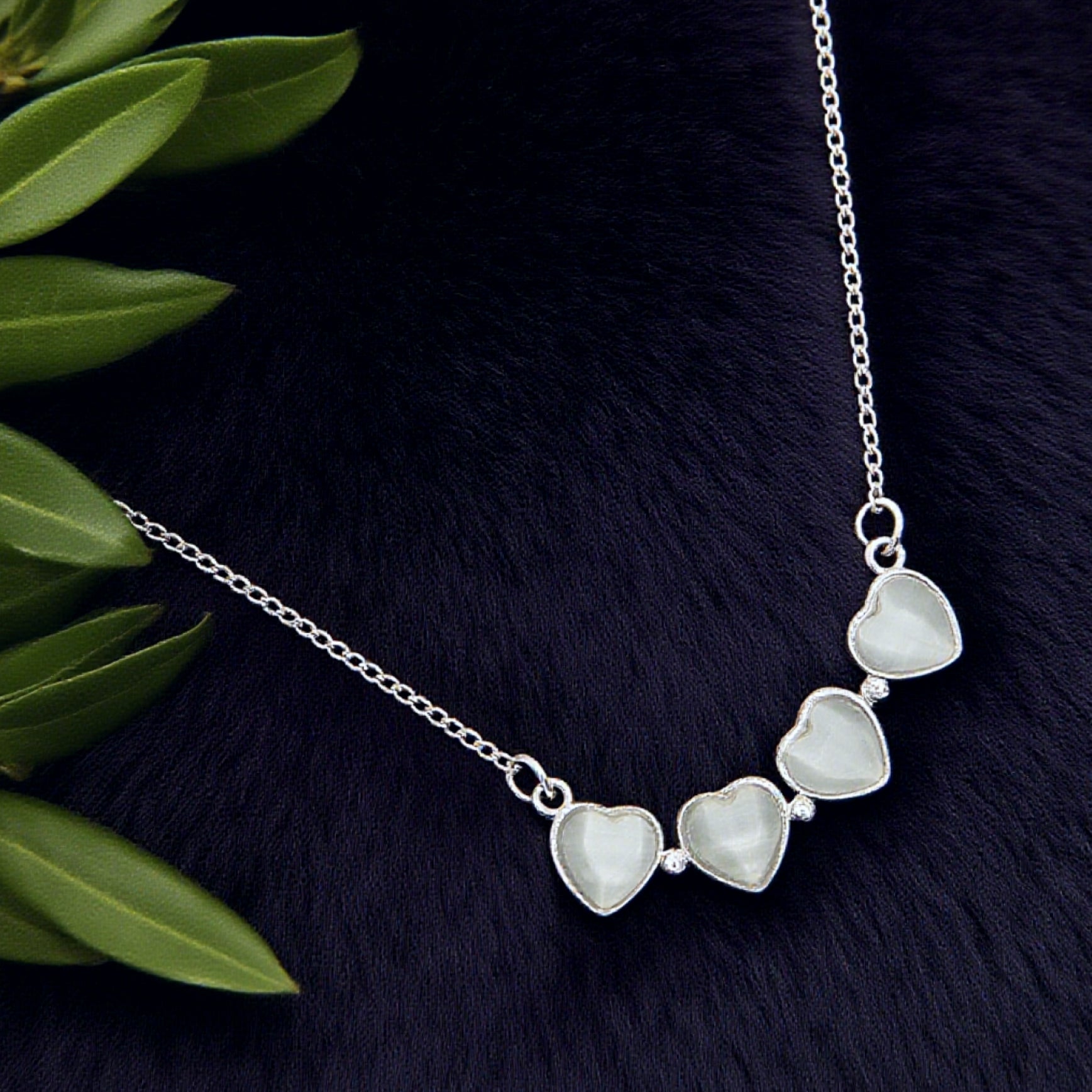 “Étreinte” Clover Pendant Necklace — Platinum‑Tone Chain, White Cat’s‑Eye Inlay