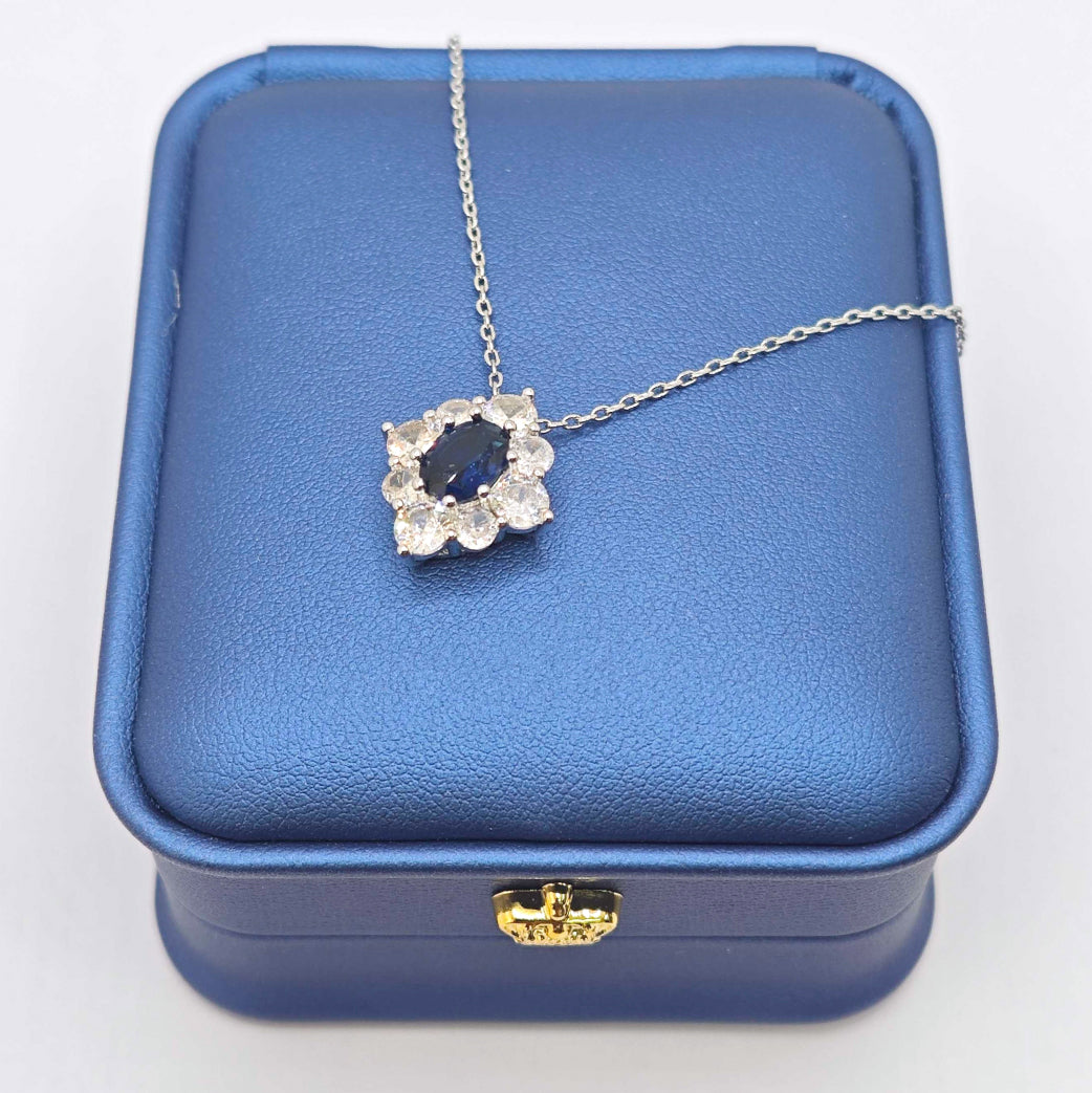 “Étreinte” Royal Halo Pendant Necklace — Platinum‑Tone, Tanzanite‑Blue L’Ardeur Crystal