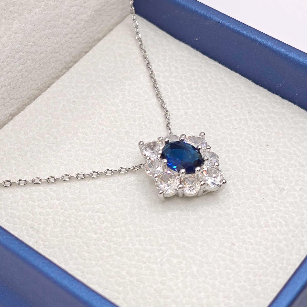 “Étreinte” Royal Halo Pendant Necklace — Platinum‑Tone, Tanzanite‑Blue L’Ardeur Crystal