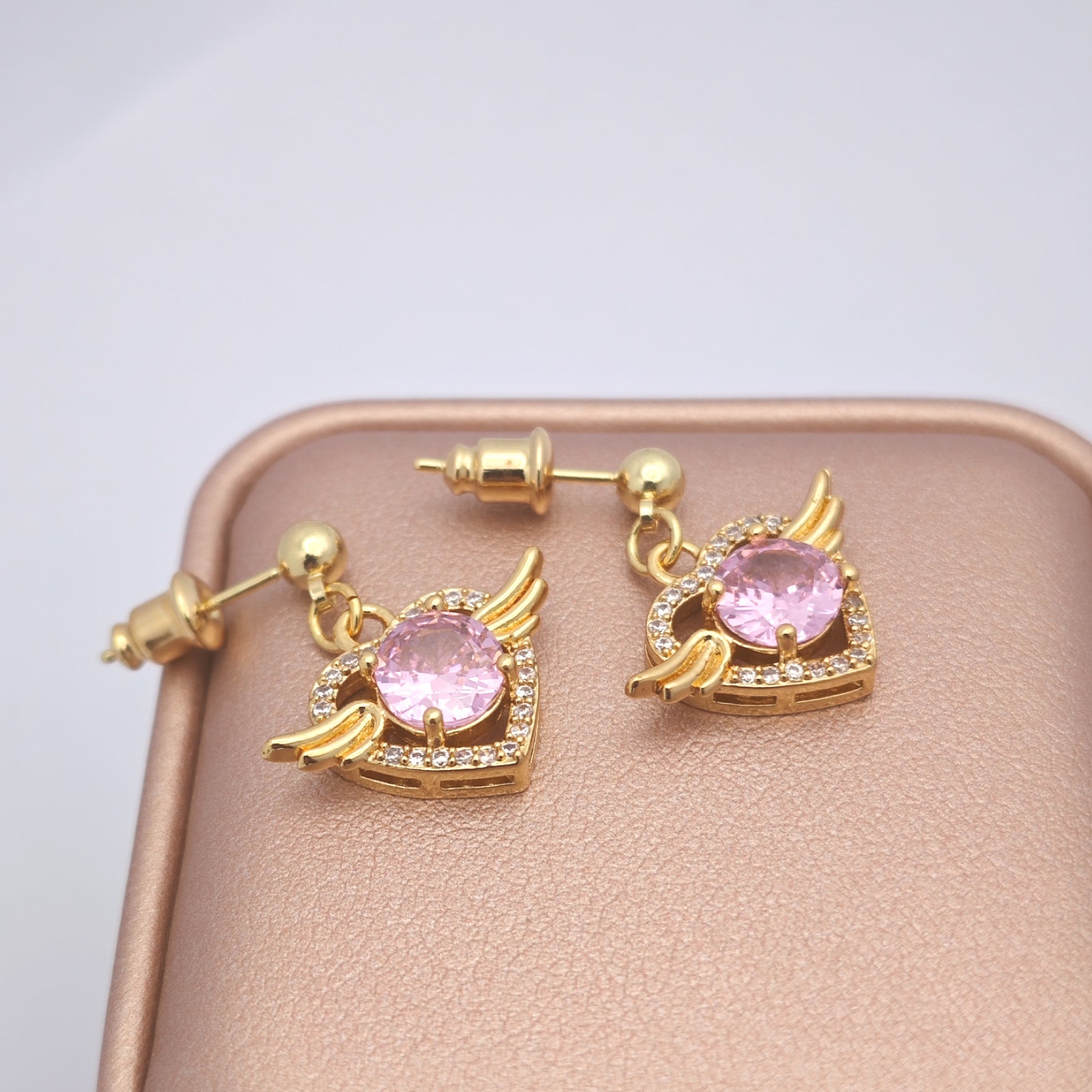 “Éclat” Angel Wing Heart Drop Earrings — 18K Gold‑Plated, Pink Diamond‑Style