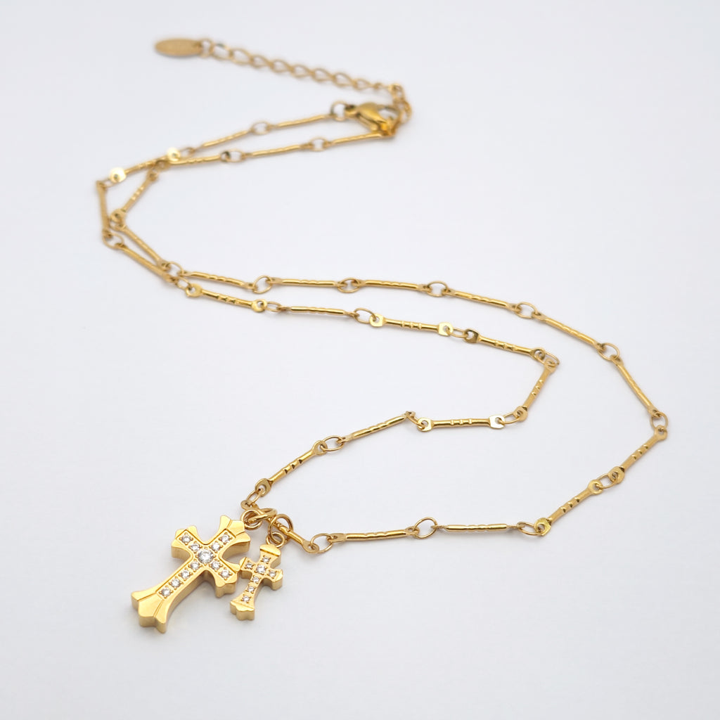 “Étreinte” Duo Cross Charm Necklace — 18K Gold‑Plated, Diamond‑Style